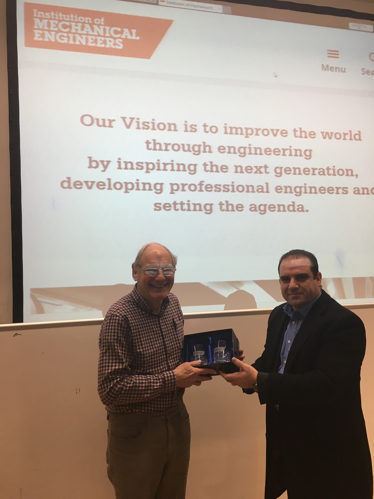 Richard Williams left receives a token of appreciation from the Committee chairman Hussam Jouhara